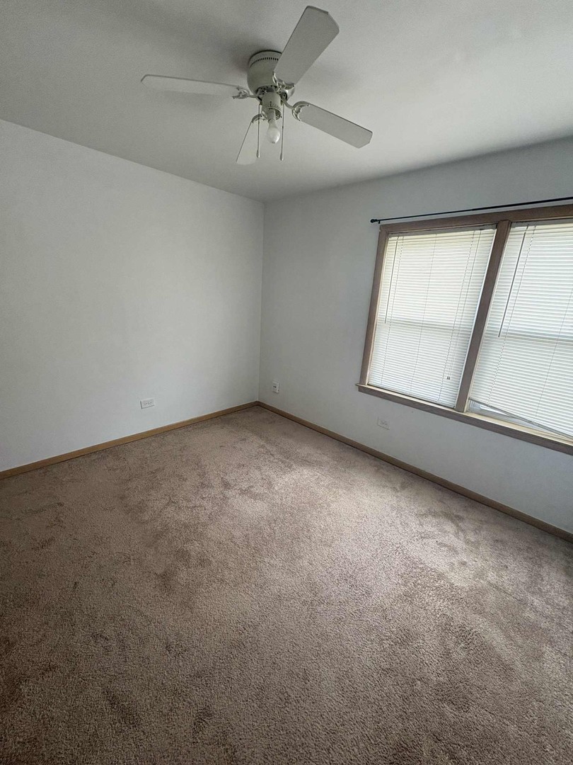 8000 South Pulaski Road, Unit 201 Chicago, IL 60652 - Photo 6 of 9 an empty room with windows and fan
