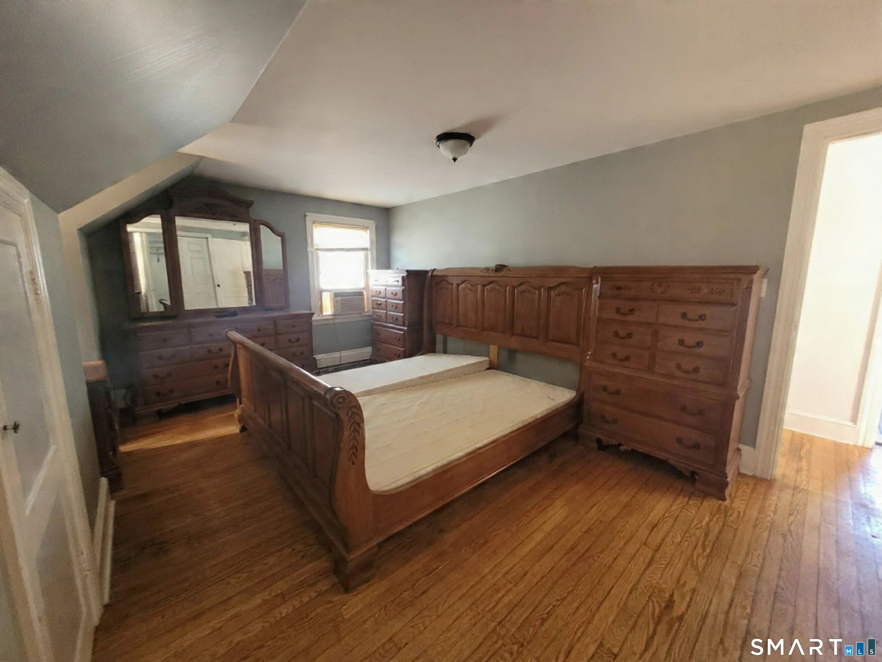 96 Tudor Street Waterbury, CT 06704 - Photo 11 of 15 a bed room with a bed and wooden floor