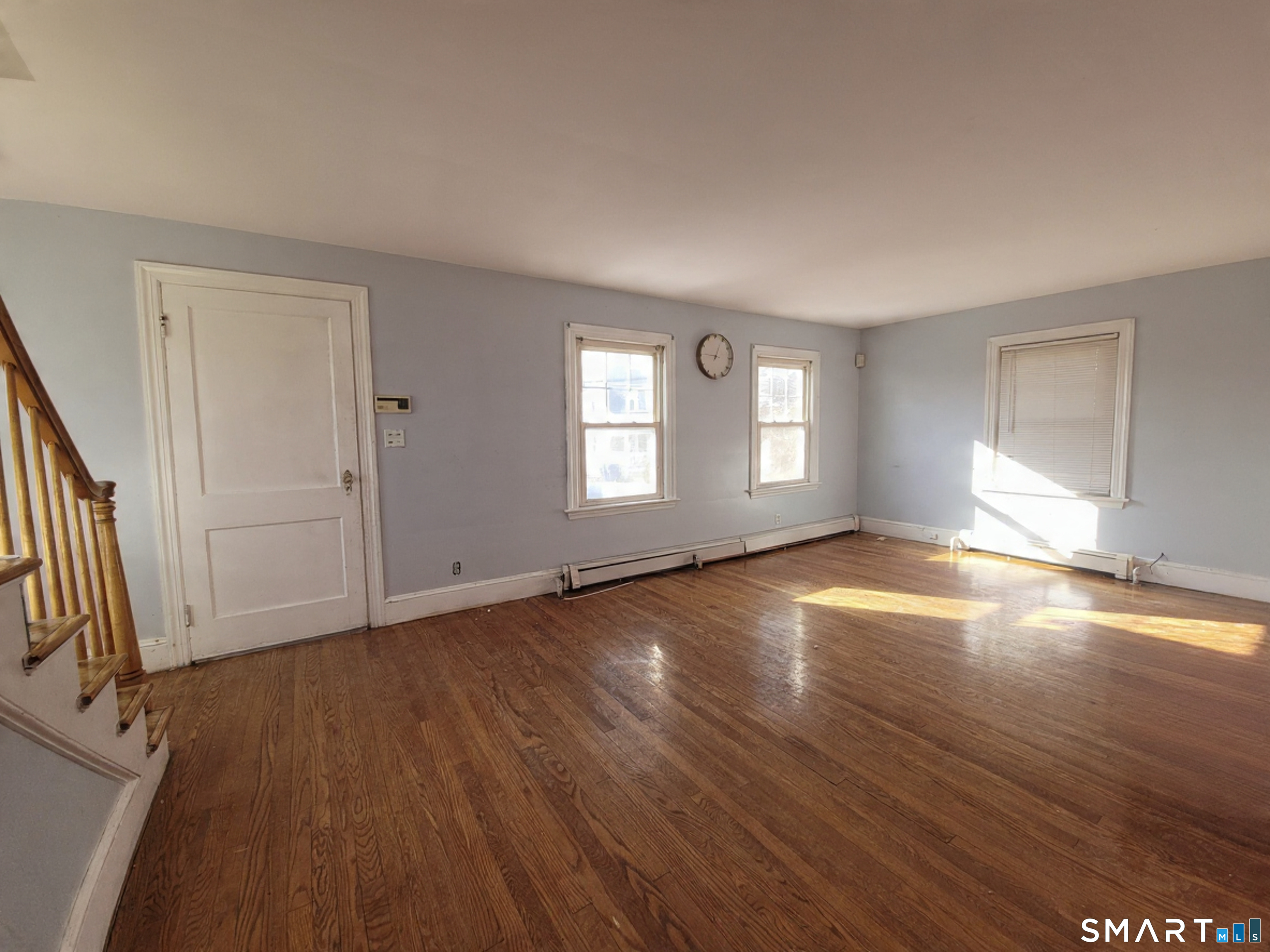 96 Tudor Street Waterbury, CT 06704 - Photo 3 of 15 an empty room with wooden floor and windows