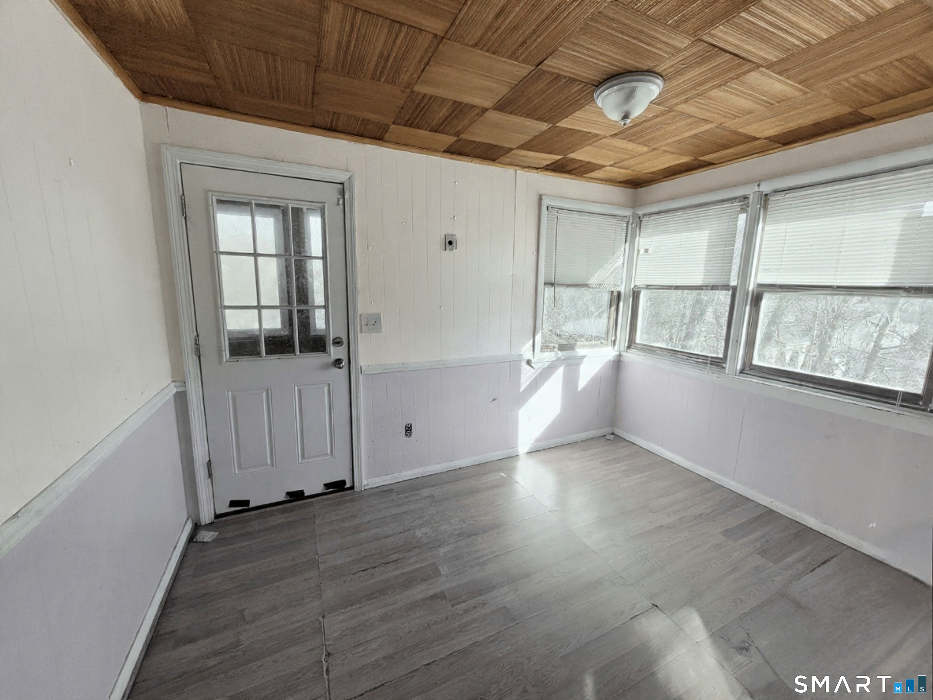 96 Tudor Street Waterbury, CT 06704 - Photo 6 of 15 an empty room with wooden floor and windows