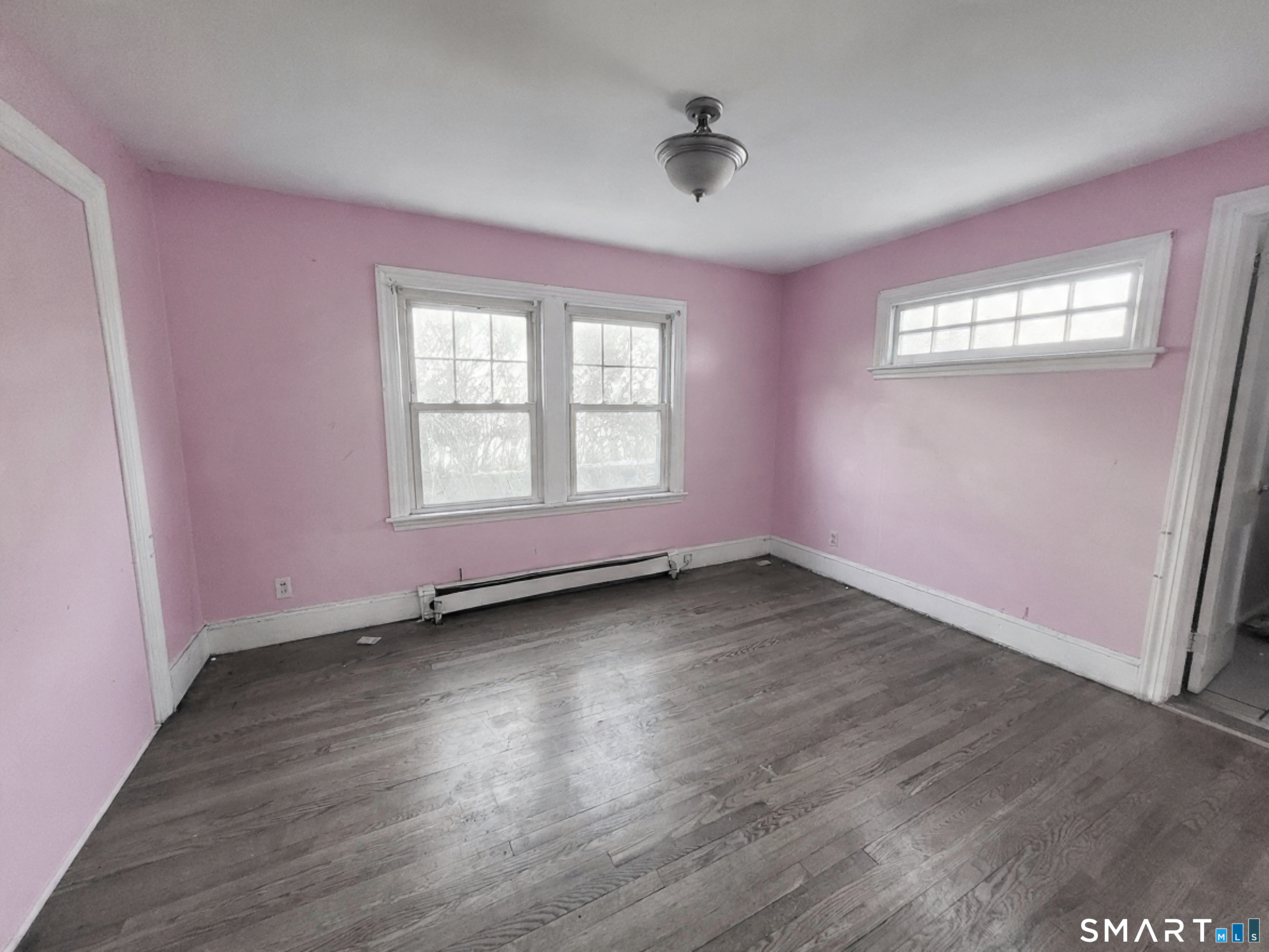 96 Tudor Street Waterbury, CT 06704 - Photo 7 of 15 a view of an empty room with wooden floor and a window