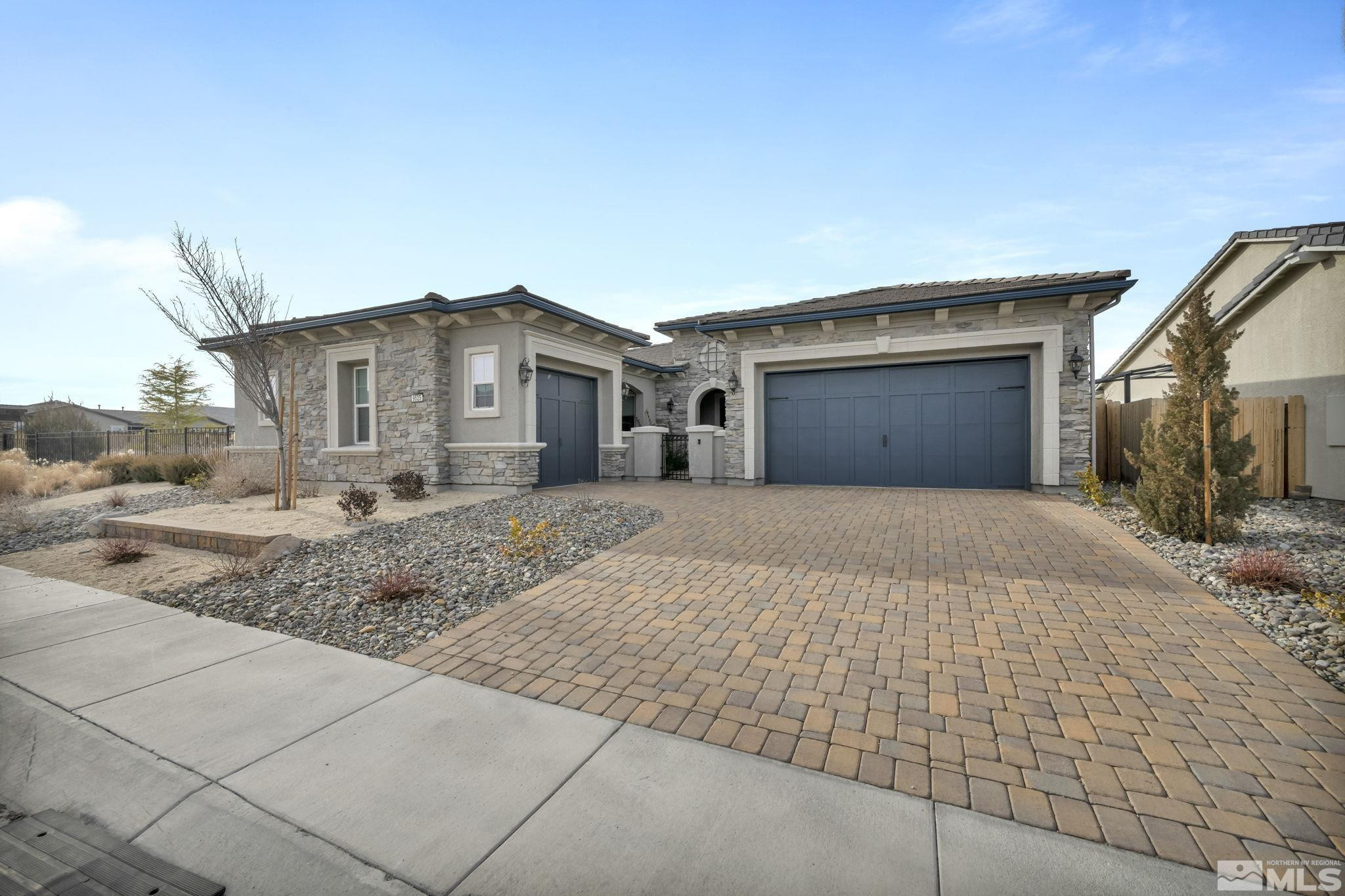 9525 Copper Sky Drive Reno, NV 89521 - Photo 1 of 40 a front view of a house with a yard