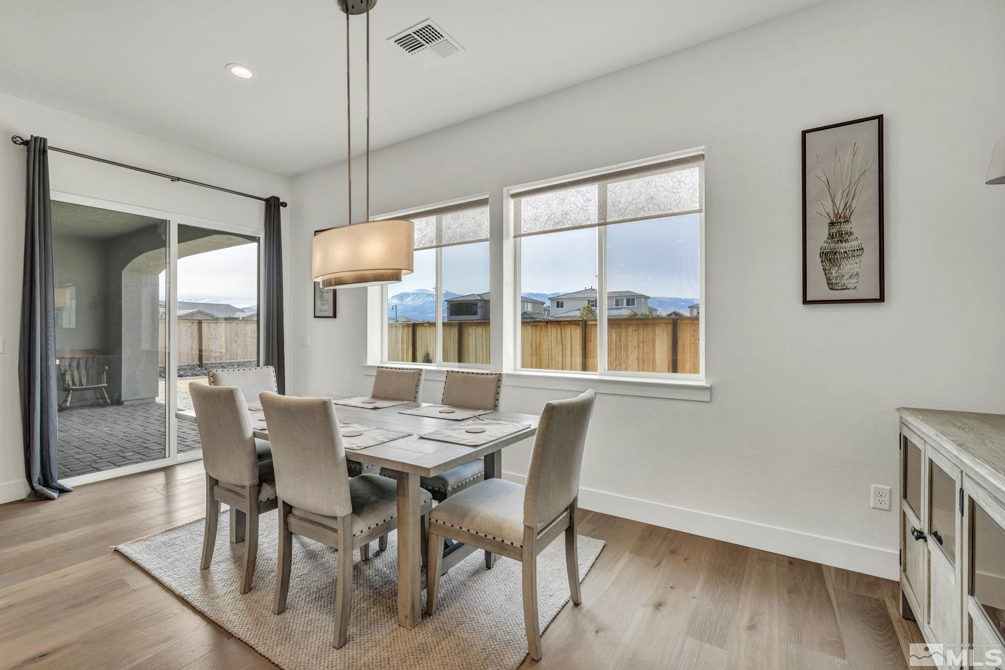 9525 Copper Sky Drive Reno, NV 89521 - Photo 15 of 40 a dining room with furniture a chandelier and wooden floor