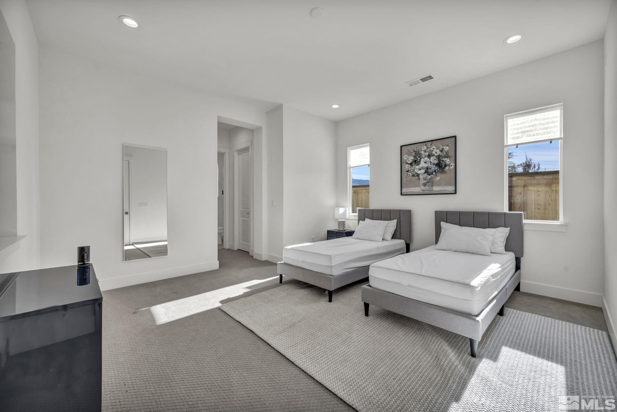9525 Copper Sky Drive Reno, NV 89521 - Photo 28 of 40 a spacious bedroom with a bed and a couch