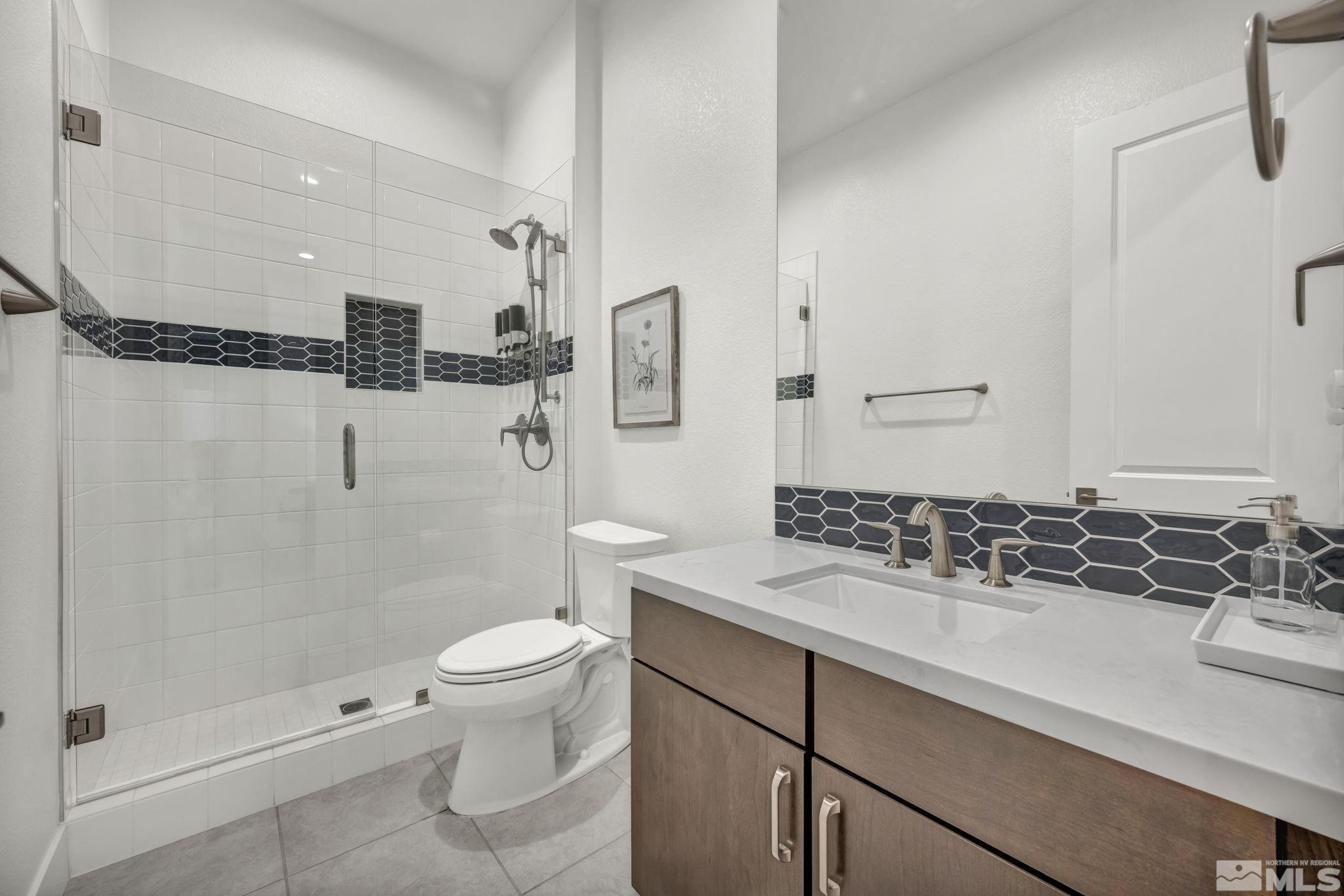 9525 Copper Sky Drive Reno, NV 89521 - Photo 29 of 40 a bathroom with a sink a toilet and shower