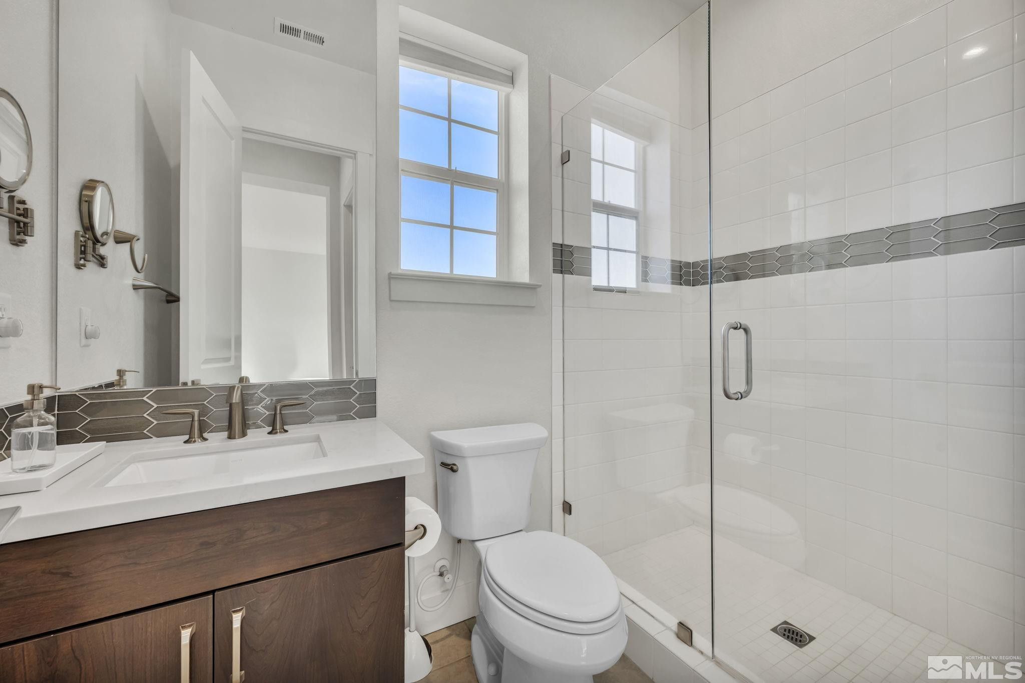 9525 Copper Sky Drive Reno, NV 89521 - Photo 30 of 40 a bathroom with a sink toilet vanity and shower