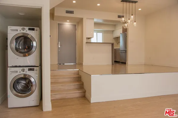 a view of a hallway with washer and dryer