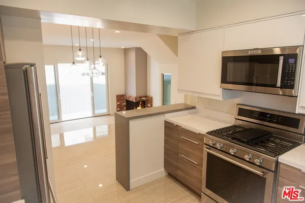 a kitchen with a refrigerator stove and microwave