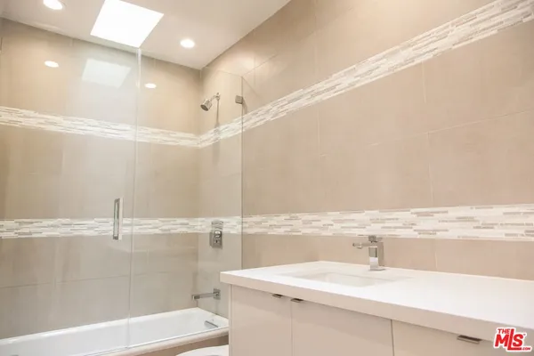 a bathroom with a sink a toilet and a tub