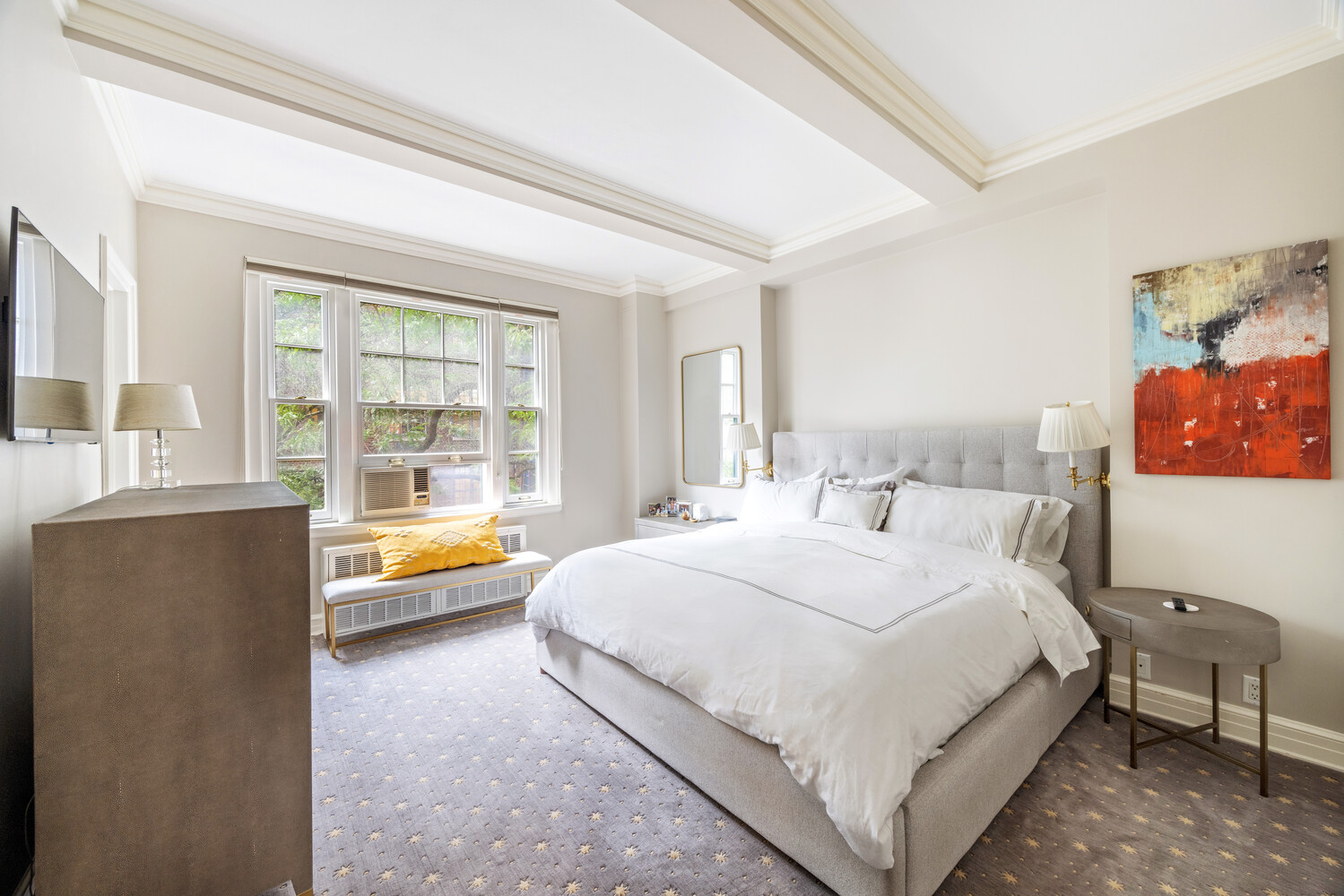 125 East 74th Street, Unit 4A Manhattan, NY 10021 - Photo 6 of 10 a spacious bedroom with a bed and a large window