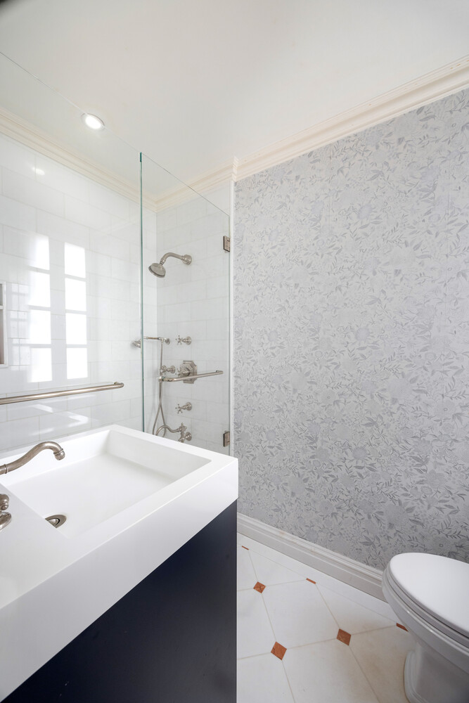 125 East 74th Street, Unit 4A Manhattan, NY 10021 - Photo 7 of 10 a bathroom with a sink a toilet and shower