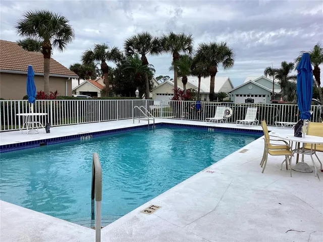a tall yellow building with lots of tress in front of it