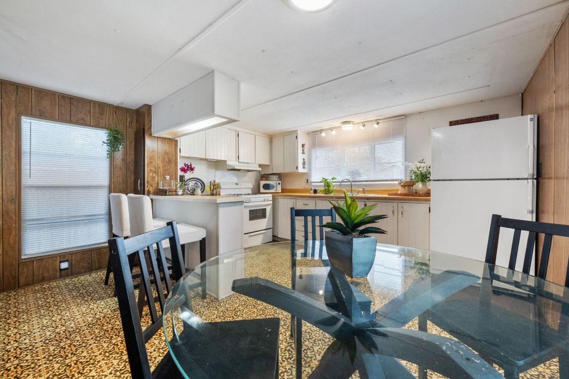 5811 Nancy Drive Austin, TX 78745 - Photo 11 of 26 a dining room filled chandelier and wooden floor