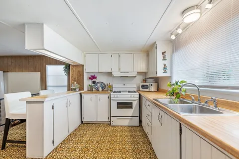 a kitchen with a sink stove and cabinets