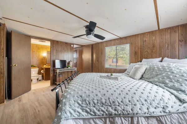 a bedroom with a bed and a flat screen tv