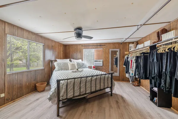 a bedroom with a bed and a window
