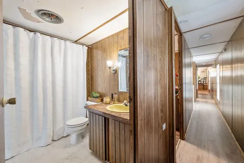a bathroom with a double vanity sink toilet and shower