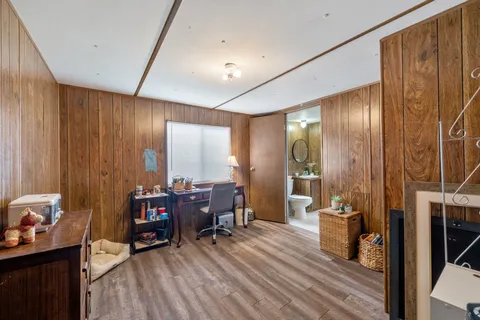 a view of a livingroom with furniture window and wooden floor