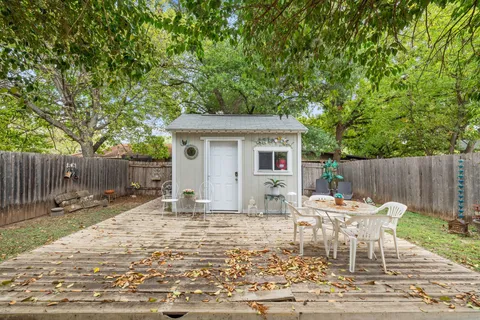 a backyard of a house with yard and outdoor seating