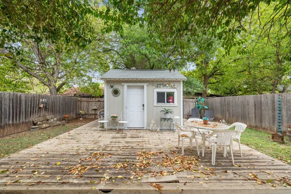 a backyard of a house with yard and outdoor seating