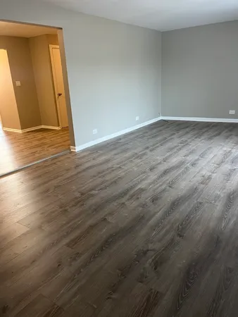 an empty room with wooden floor