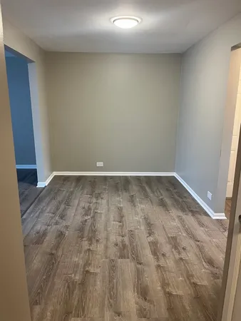 a view of a room with wooden floor