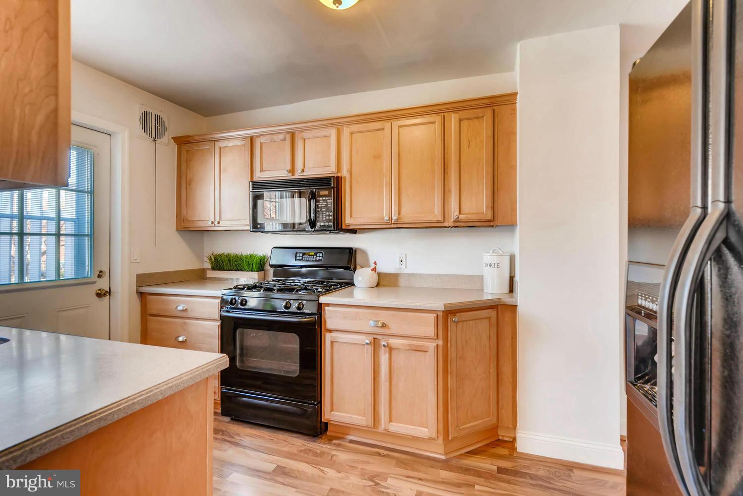 1612 Feldbrook Road Towson, MD 21286 - Photo 4 of 30 CORIAN COUNTERTOPS AND LAMINATE WIDE PLANK FLOORS