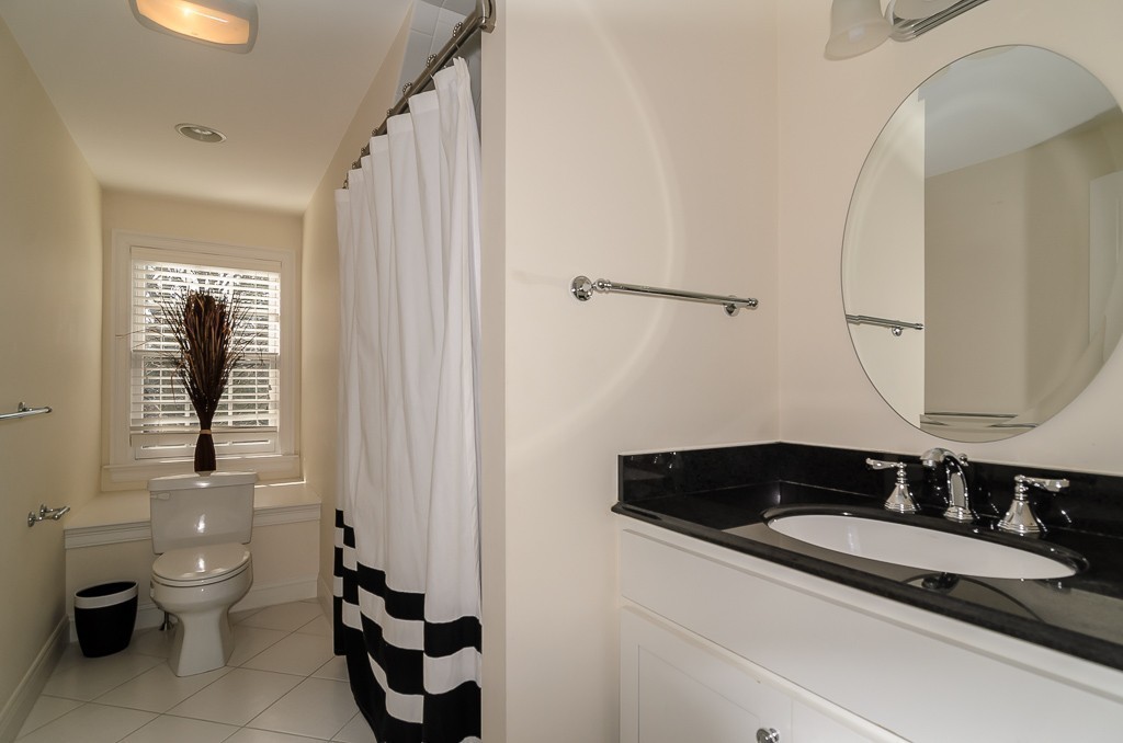 14 Massasoit Road Wellesley, MA 02481 - Photo 17 of 29 a bathroom with a sink and a mirror