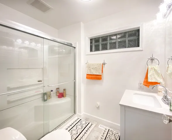 a bathroom with a shower and a sink