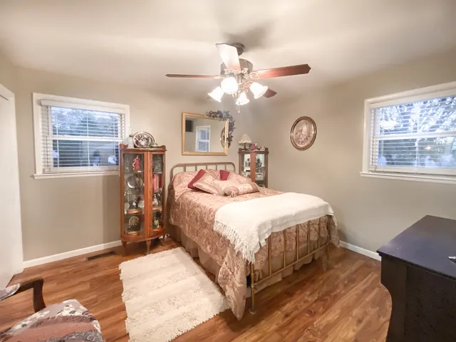 a bedroom with a large bed and a chandelier