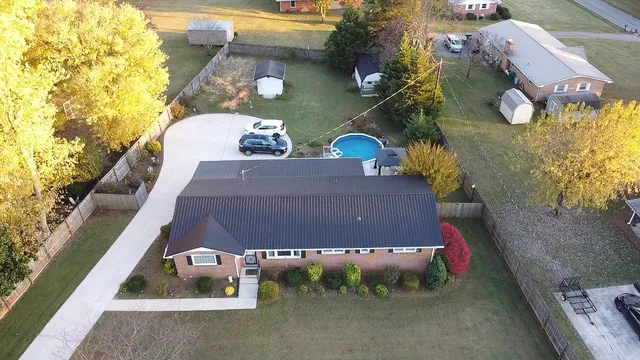 an aerial view of a house with garden space pool seating area and yard