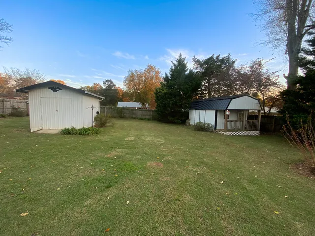 a balcony with couple of chairs and a couch