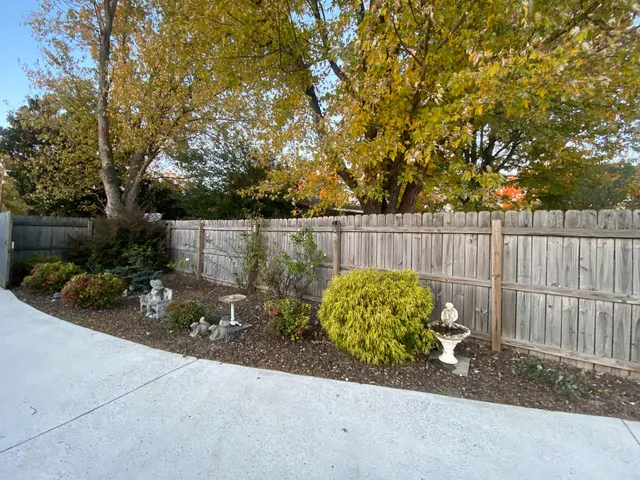 a view of a patio with a table and chairs