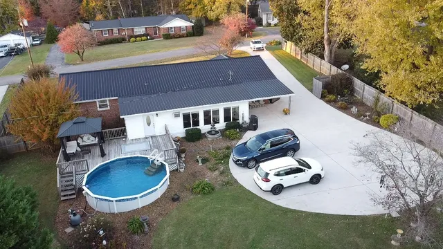a view of a backyard with large trees