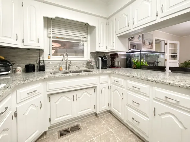 a kitchen with a sink cabinets and window