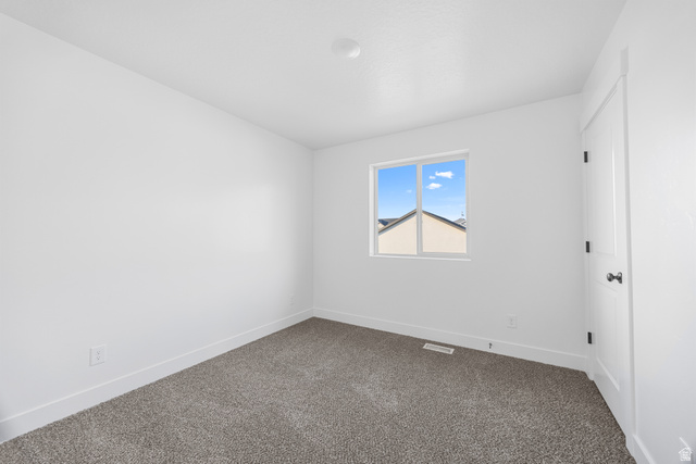1563 South Deerbrook Road, Unit 267CHM Santaquin, UT 84655 - Photo 10 of 12 Carpeted interior room with white walls and baseboards