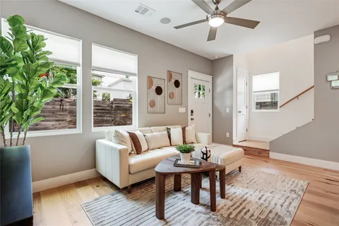 a living room with a large window and a fireplace