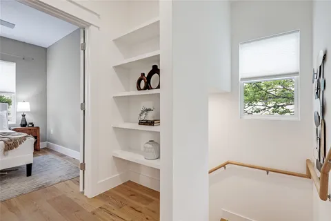 a bed sitting in a bedroom next to a window