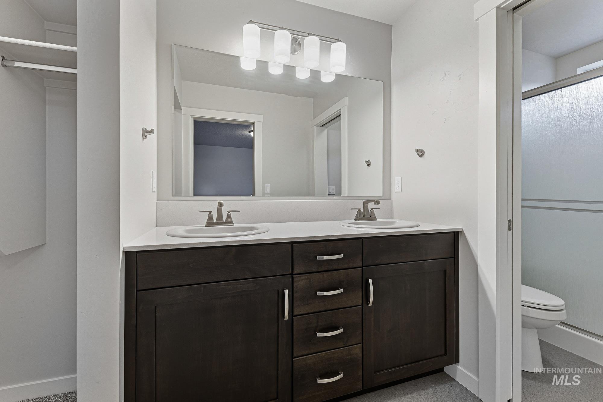 3065 North Summerbrook Avenue Meridian, ID 83646 - Photo 19 of 33 Full bath with double vanity and an enclosed shower