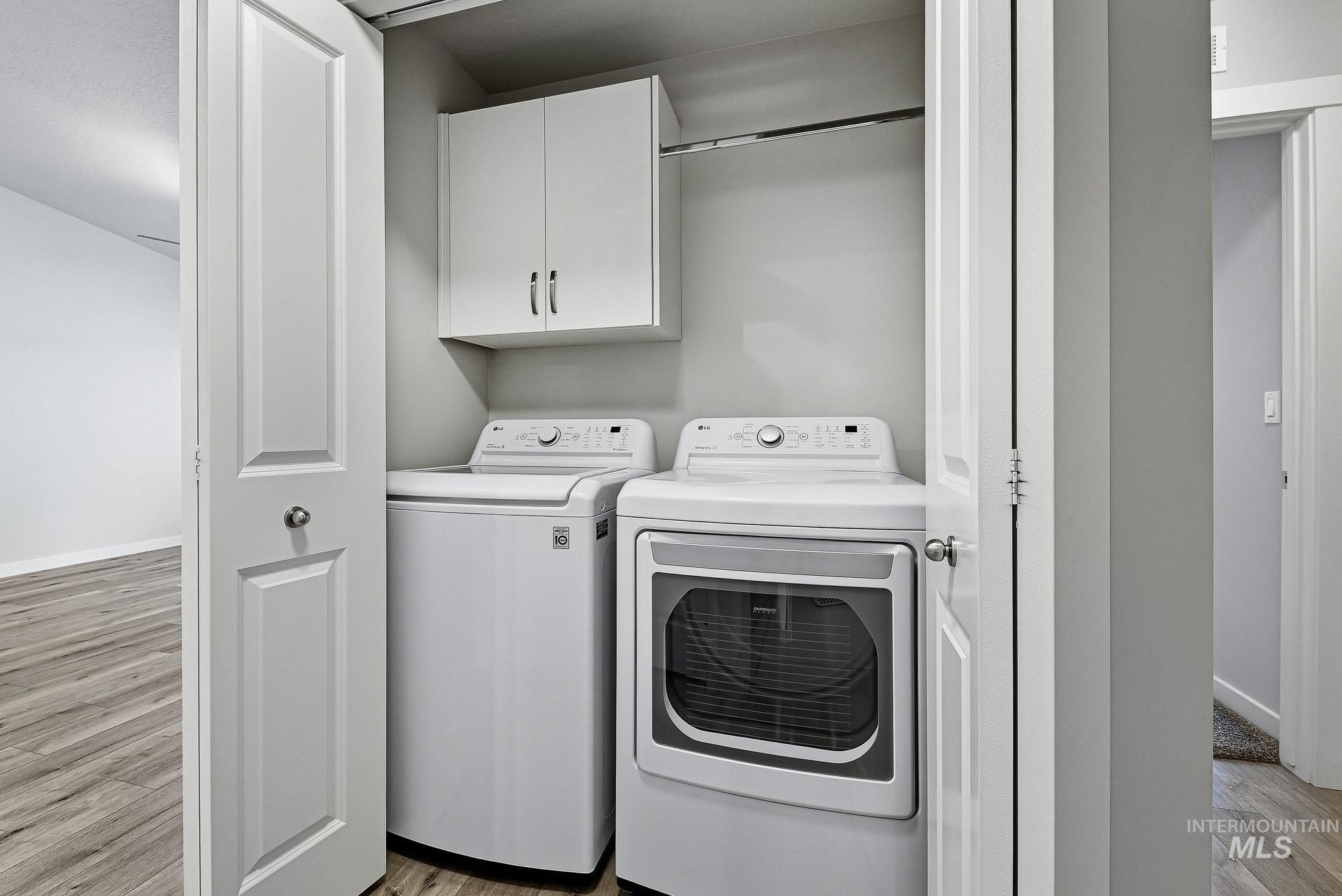 3065 North Summerbrook Avenue Meridian, ID 83646 - Photo 28 of 33 Laundry area with light wood-type flooring, cabinet space, and independent washer and dryer