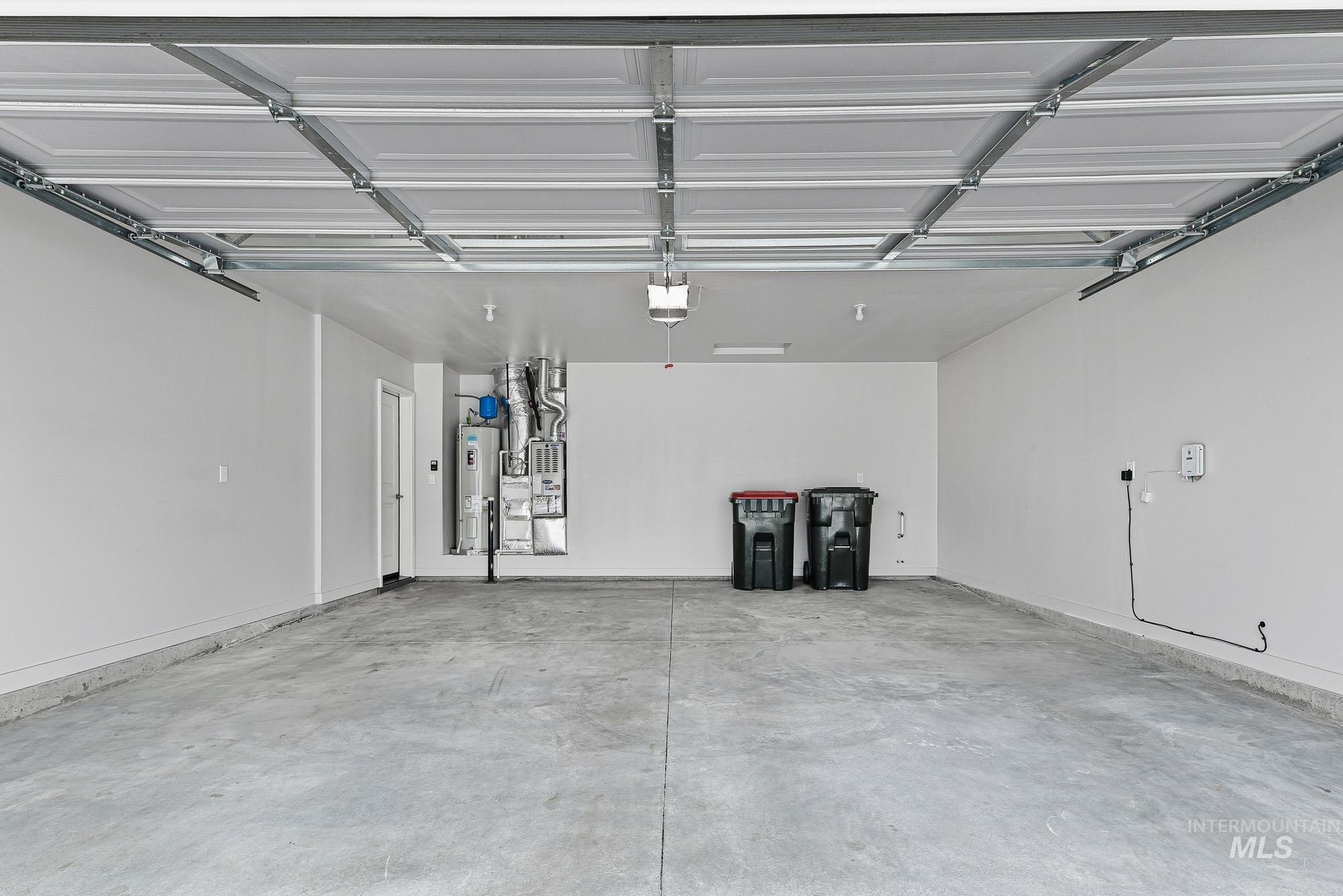 3065 North Summerbrook Avenue Meridian, ID 83646 - Photo 29 of 33 Garage featuring electric water heater and heating unit