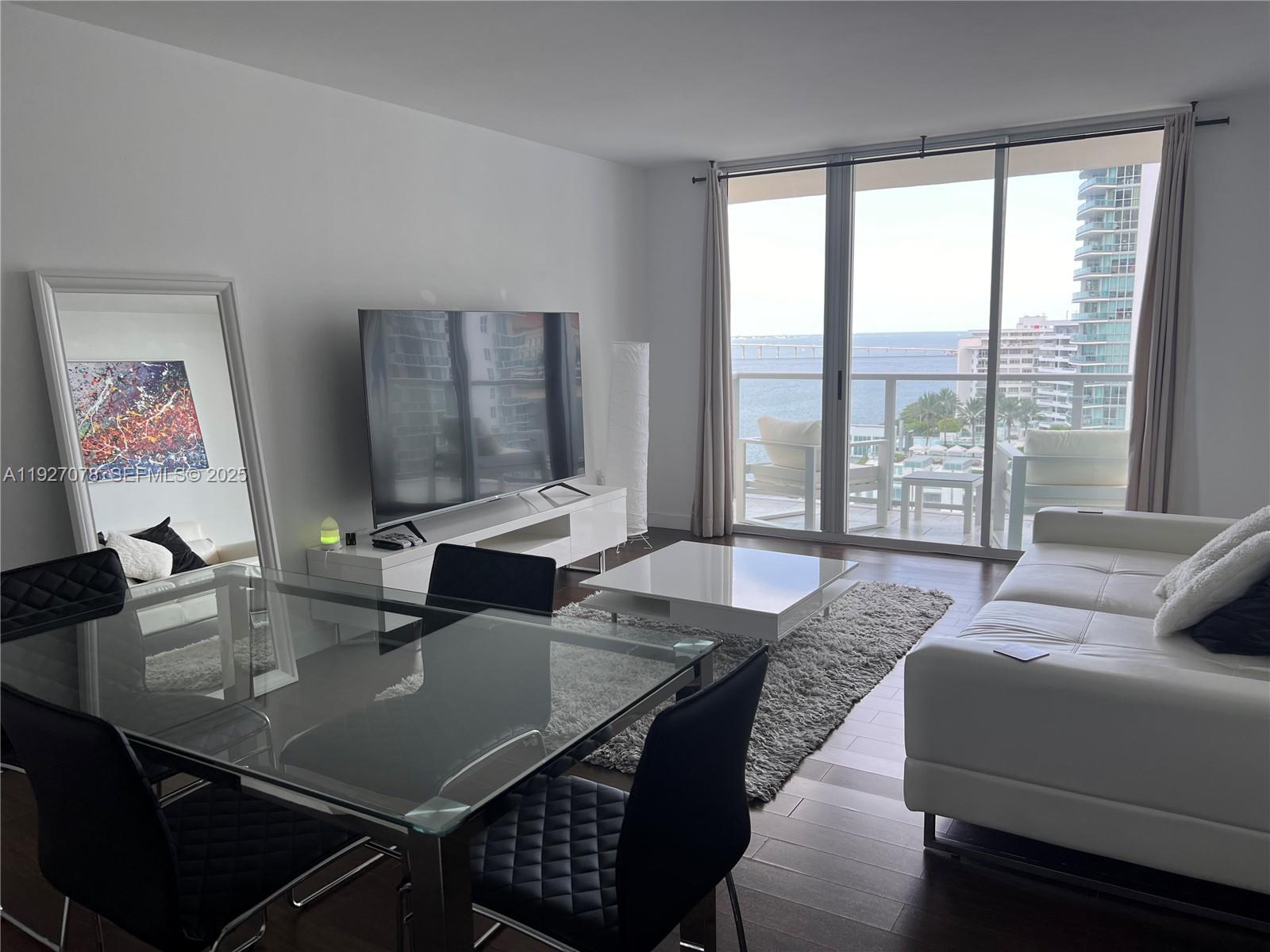 1155 Brickell Bay Drive, Unit 1607 Miami, FL 33131 - Photo 3 of 9 a view of a dining room with furniture and window