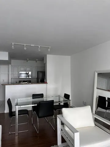 a kitchen with a table and chairs in it