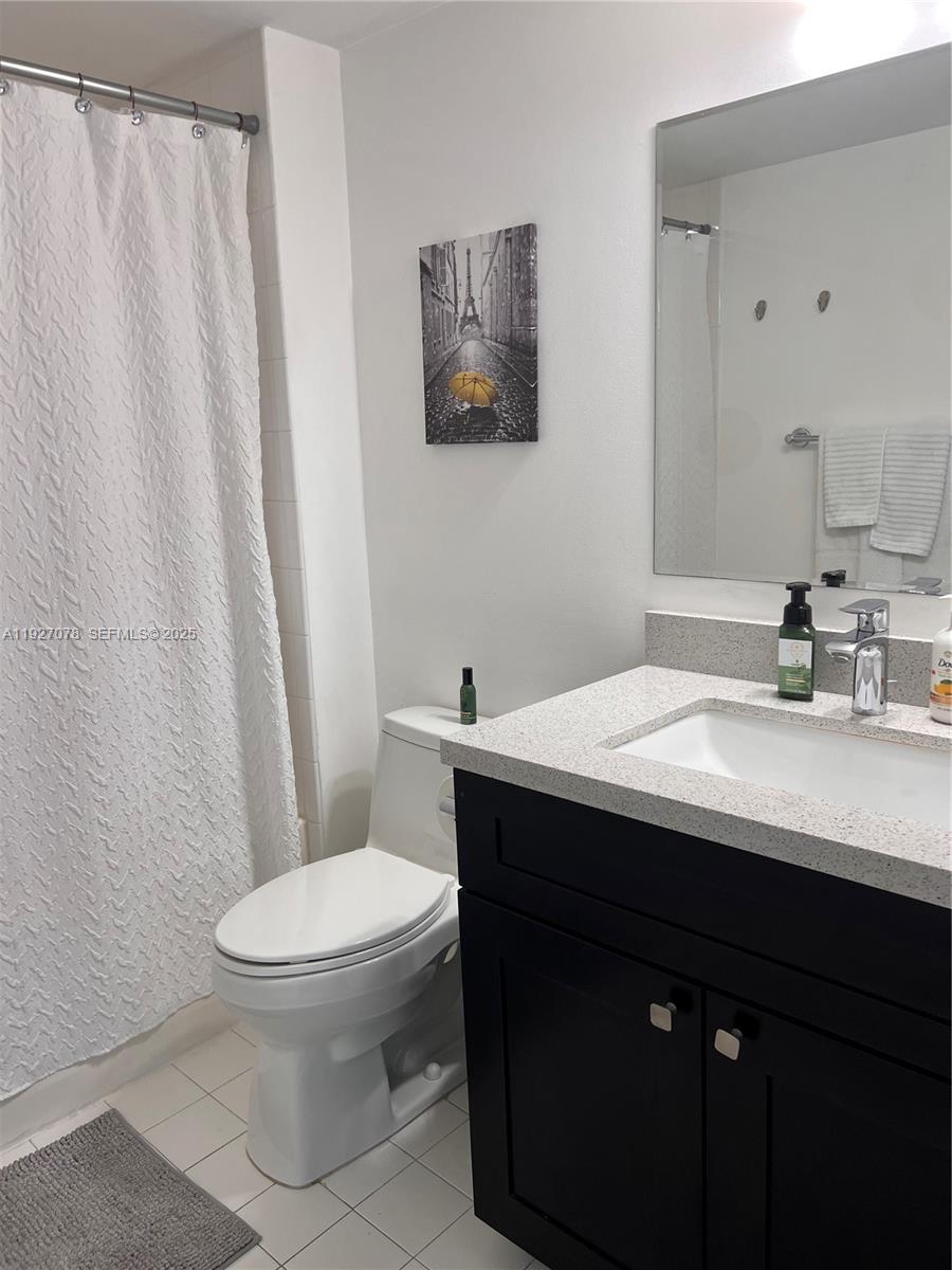 1155 Brickell Bay Drive, Unit 1607 Miami, FL 33131 - Photo 9 of 9 a bathroom with a sink a toilet and a mirror