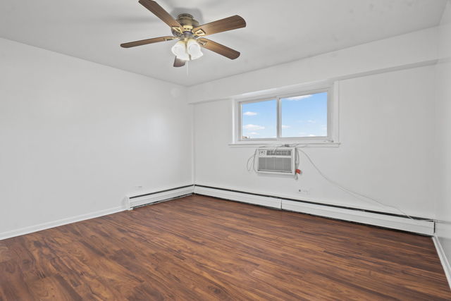 7540 North Ridge Boulevard, Unit 5D Chicago, IL 60645 - Photo 13 of 15 wooden floor in an empty room with a window