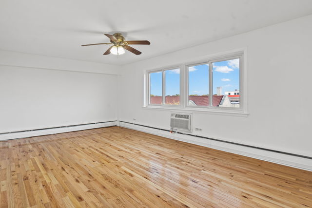 7540 North Ridge Boulevard, Unit 5D Chicago, IL 60645 - Photo 7 of 15 a view of empty room with wooden floor and fan