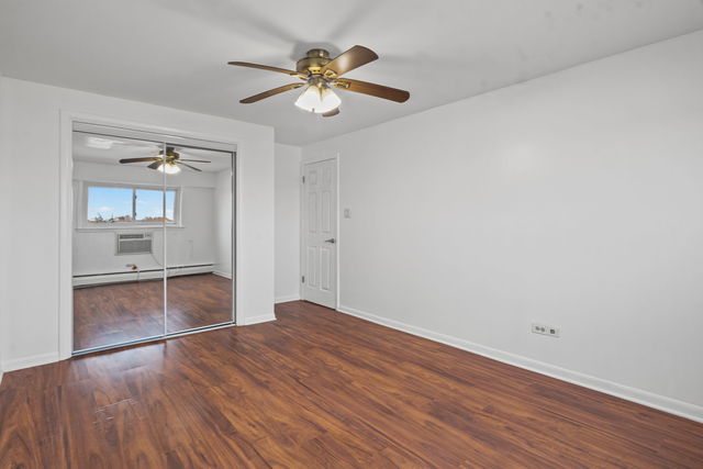 7540 North Ridge Boulevard, Unit 5D Chicago, IL 60645 - Photo 9 of 15 wooden floor in an empty room with a window