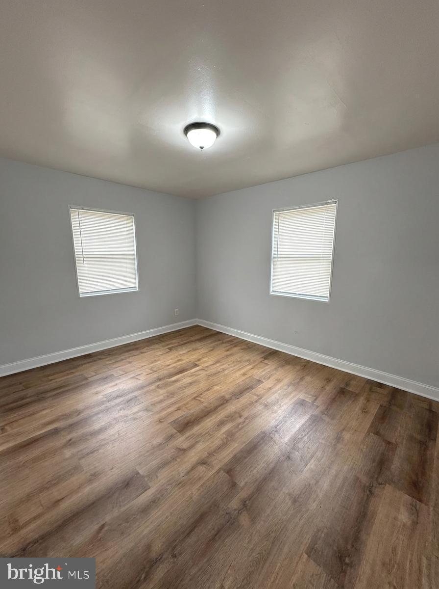 2100 Channing Street Northeast, Unit 2A Washington, DC 20018 - Photo 5 of 7 an empty room with wooden floor and windows