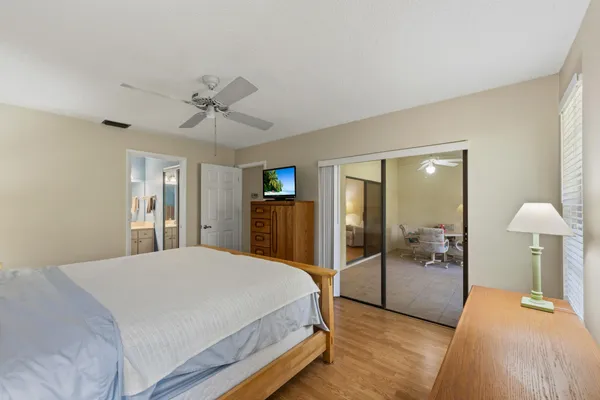 a spacious bedroom with a bed and a chandelier