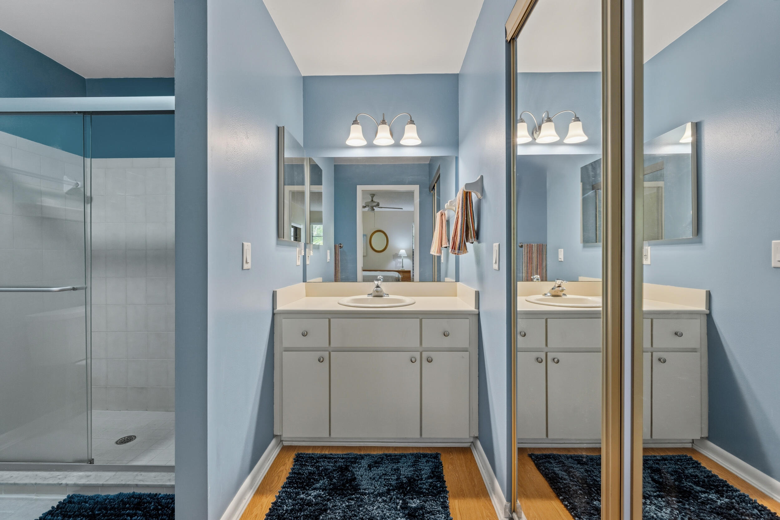 7873 Southeast Sugar Sand Circle Hobe Sound, FL 33455 - Photo 17 of 35 a bathroom with a double vanity sink mirror and shower